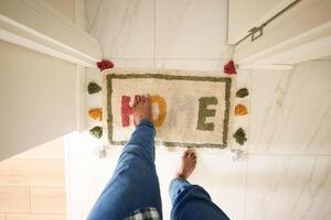 a rug with the word home written on it is on the floor in a hallway photo