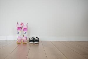 Child cerebral palsy disability legs orthosis and shoes on a wooden floor photo