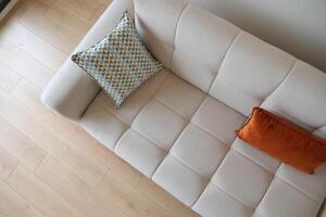 modern sofa with pillows in living room at home photo