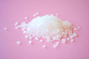 Salt crystals on pink background photo