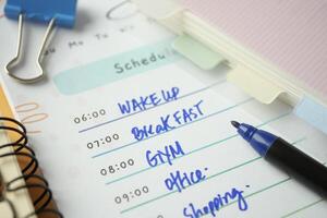 Closeup of weekly planner on table. photo