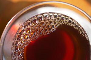 Closeup of tea cup with bubble forming photo