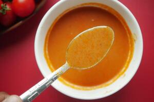 fresh tomato soup on table photo