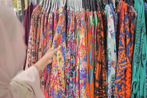 woman choosing clothes in shop. photo