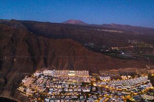 Top view of the houses located on the rock of Los Gigantes at sunset, Tenerife, Canary Islands, Spain photo