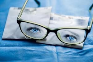 Drawn women's eyes on glasses. Eyes reflection in spectacles. photo