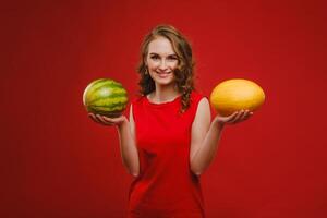 Photo of wavy cheerful curly casual positive cute nice charming pretty girlfriend smiling toothily having fetched you a watermelon isolated over vivid orange color background