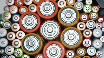 Rows of used alkaline AA, AAA, D batteries. Lithium ion battery pack close up video