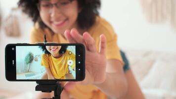 Art Bloggers, Online Lesson Recording, Woman Blogger, Playing Guitar. Cheerful afro american woman blogger playing guitar while sitting using mobile phone video