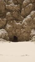 A group of rocks on a sandy beach video