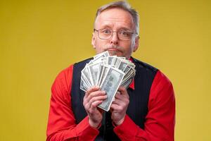 man holding lots of dollar bills in hands photo