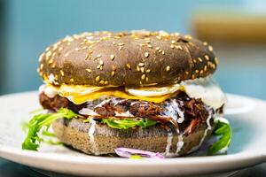 Delicious yummy fastfood concept. Juicy hamburger on a plate. photo