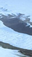 Snow-covered mountain range taken from above video