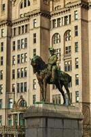 Equestrian statue in front of a historic building with intricate architecture in Liverpool, UK. photo