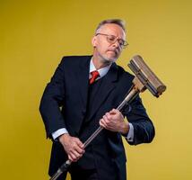 Adult man singing in mop. Holding broom like microphone. Man in suit. photo