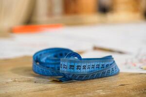 Measuring tape. Selective focus with blurred background. Tailor s work. Tailor concept. Close-up. photo