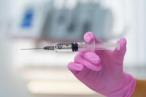 Medical concept with syringe for vaccination isolated on blurred background. photo