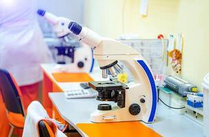 Study under the microscope in the laboratory. DNA research and methods of diseases identification. photo