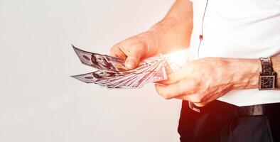 Hand with money isolated on a white background. Dollars in hands photo