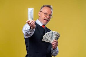 Portrait of super excited senior mature man who just won lots of money. Isolated on white background. Positive emotions facial expression feelings. Closeup. photo