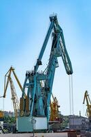 Container cargo freight ship with working crane bridge in shipyard at daytime. Logistic import export background at sun light. photo