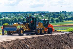 Heavy duty bulldozer at work. Heavy special machines. Road constraction, repairing. Selective focus. photo