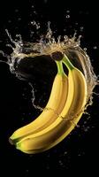 AI generated bananas are being splashed with water on a black background photo
