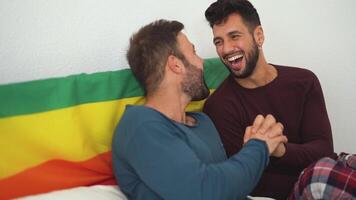 two men laughing and smiling in bed video