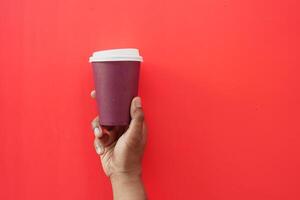 holding a red take away kraft coffee cup photo