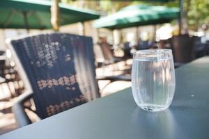 glass of water on a cafe table outdoor photo