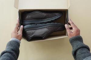 Set with stylish shoes and cardboard boxes on color background. photo