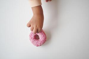 top view of child hand pick chocolate donut photo