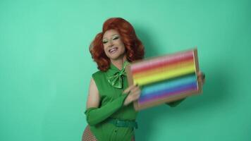 Happy drag queen celebrating gay pride holding banner with rainbow flag symbol of LGBTQ social movement video