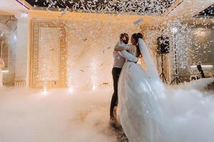 the wedding of the bride and groom in an elegant restaurant with great light and atmosphere. The first dance of the bride and groom. photo