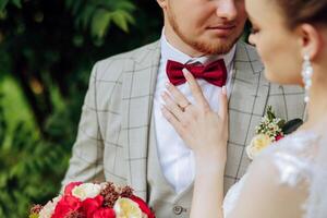 The bride and groom look at each other on their wedding day. Over the shoulder shot of a wedding couple. Tenderness and love in the eyes. photo