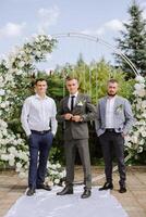 Wedding photography. The groom and his friends photo