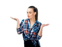 ortrait of clueless young woman with arms out asking what's the problem, who cares, so what, I don't know. Isolated on white background. Human emotions, facial expressions. photo