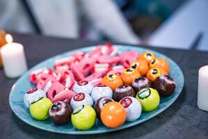 Delicious sweets on candy buffet. Wedding candy bar decoration setup with delicious cakes and sweets. Candy bar. photo