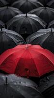 AI generated A red umbrella among the black umbrellas. Contrast concept. photo