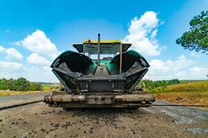 Construction site. Construction of a plant for the production of asphalt. Heavy machinery on road. photo