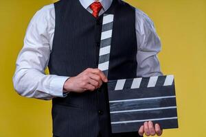 Man with movie flap while filming. Cropped photo. Film production. Human emotions. photo