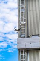 High metal frames in the construction site. Steel structure is under construction. Selective focus. Dron is flying over constructions. photo