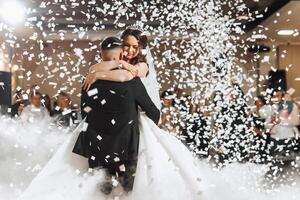 the wedding of the bride and groom in an elegant restaurant with great light and atmosphere. The first dance of the bride and groom. photo