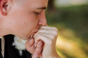 a man kisses a woman's hand. manifestation of love. He proposes to her. She said yes. Close-up photo