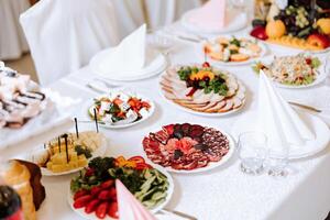 Top view of a beautifully decorated table with delicious food. Everything is ready for lunch or dinner with delicious snacks and a cozy atmosphere. photo