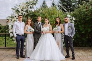 Wedding photo session in nature. The bride and groom and their friends