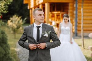 The moment of the first meeting of the bride and groom with a wedding bouquet, the bride goes to her lover in nature under the autumn sun. photo