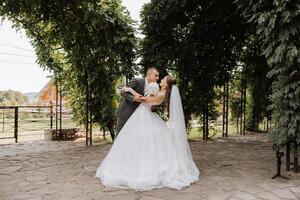 Wedding couple on a walk in the autumn park. The bride in a beautiful white dress. Love and relationship concept. Groom and bride in nature outdoors photo