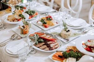 Top view of a beautifully decorated table with delicious food. Everything is ready for lunch or dinner with delicious snacks and a cozy atmosphere. photo