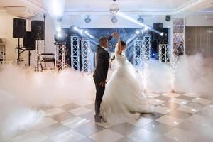 the wedding of the bride and groom in an elegant restaurant with great light and atmosphere. The first dance of the bride and groom. photo